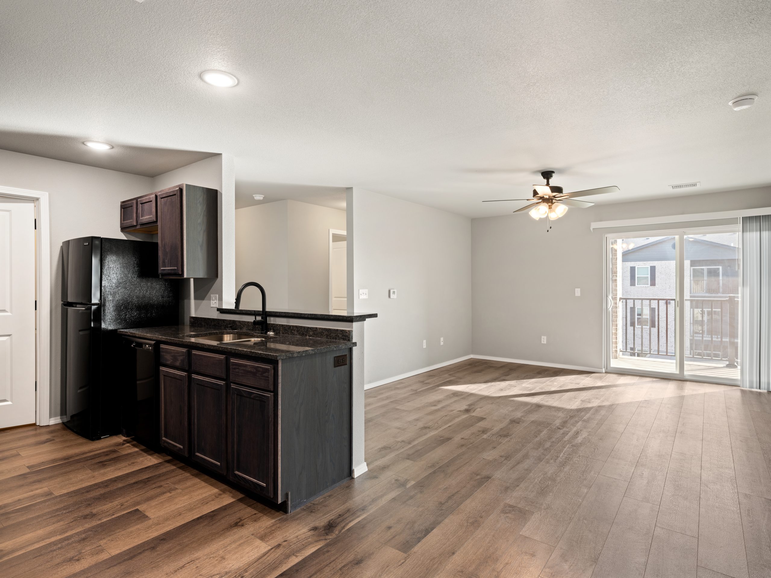 View of living room from the kitchen at 20th Place Apartments