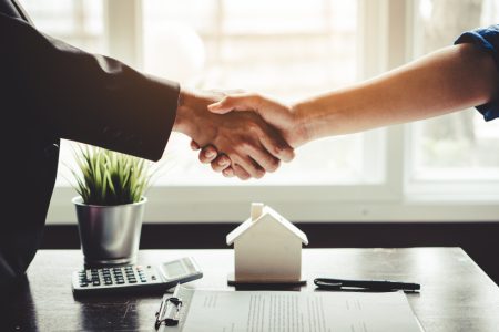 Property manager and tenant shaking hands