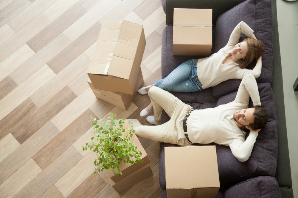 Couple Sitting on Couch With Boxes