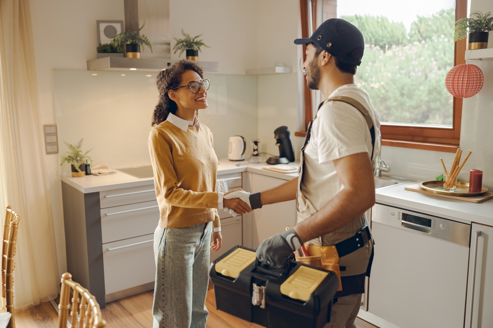 Maintenance repair man shaking hands with a tenant