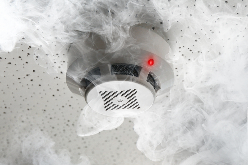 A smoke detector with smoke indicating an apartment emergency