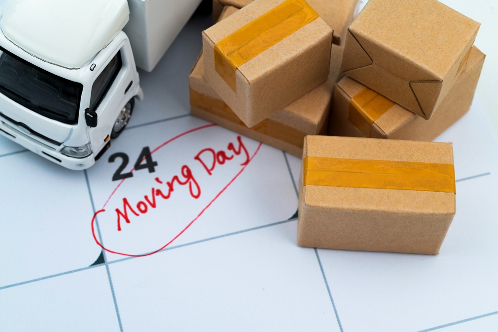 Apartment moving day on calendar with mini boxes and truck
