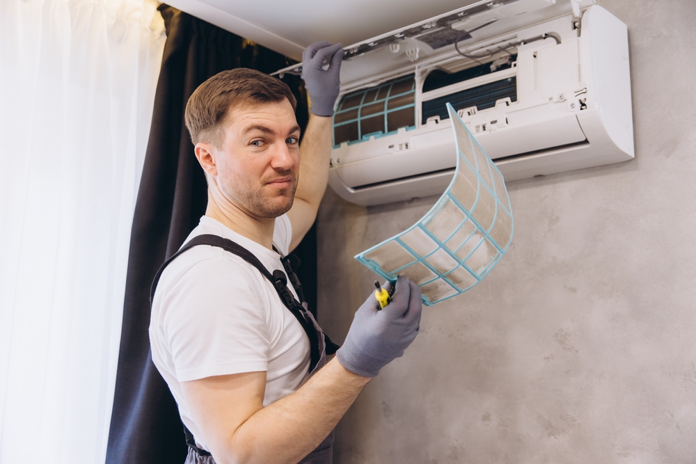 Maintenance worker holding a dirty air filter