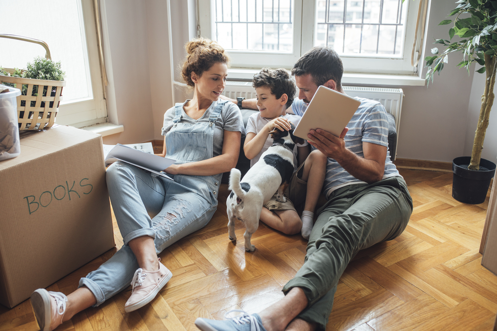 Parents and child in a new apartment with their dog