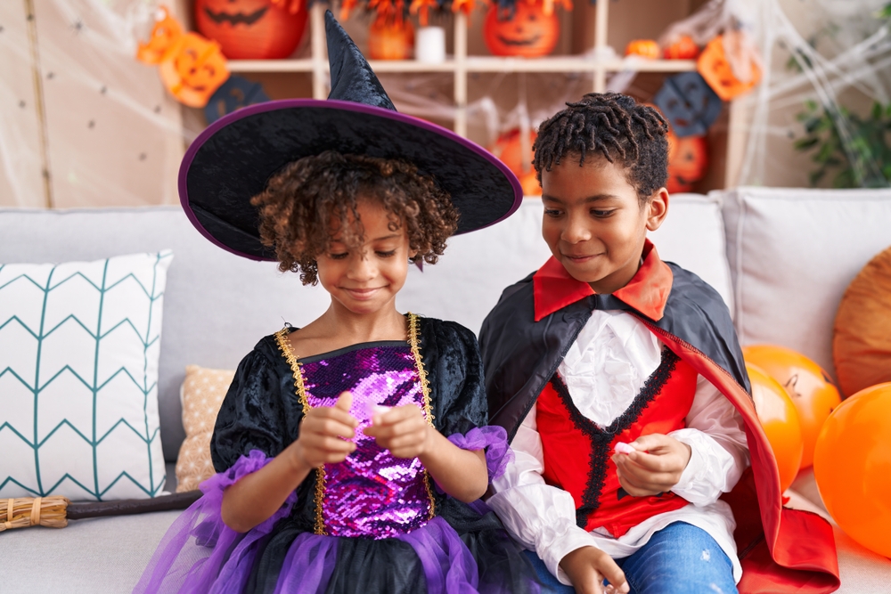 Two children in costume after Halloween apartment decorating