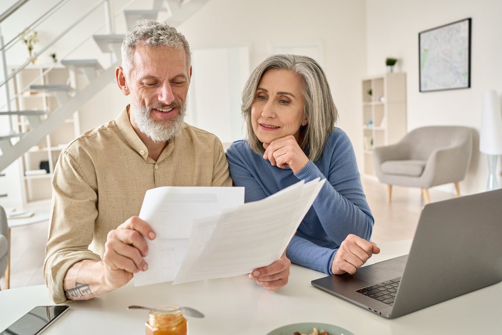 enior couple looking at apartment rental forms