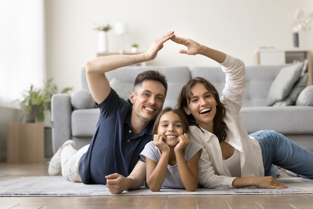miling family in their affordable apartment living room