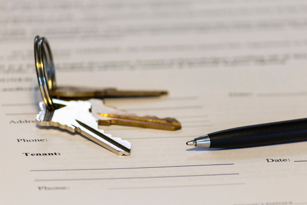 Close-up of keys and an apartment lease agreement